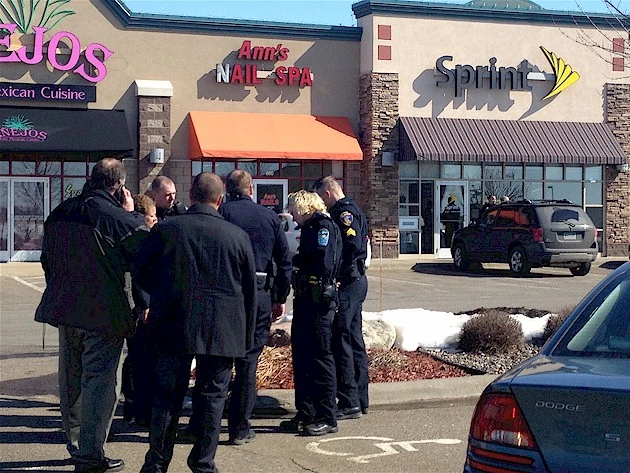 Police confer outside the Sprint Store in Sartell, the scene of what is believed to be a shooting just before noon, March 13, 2014. Police confer outside the Sprint Store in Sartell, the scene of what is believed to be a shooting just before noon, March 13, 2014.