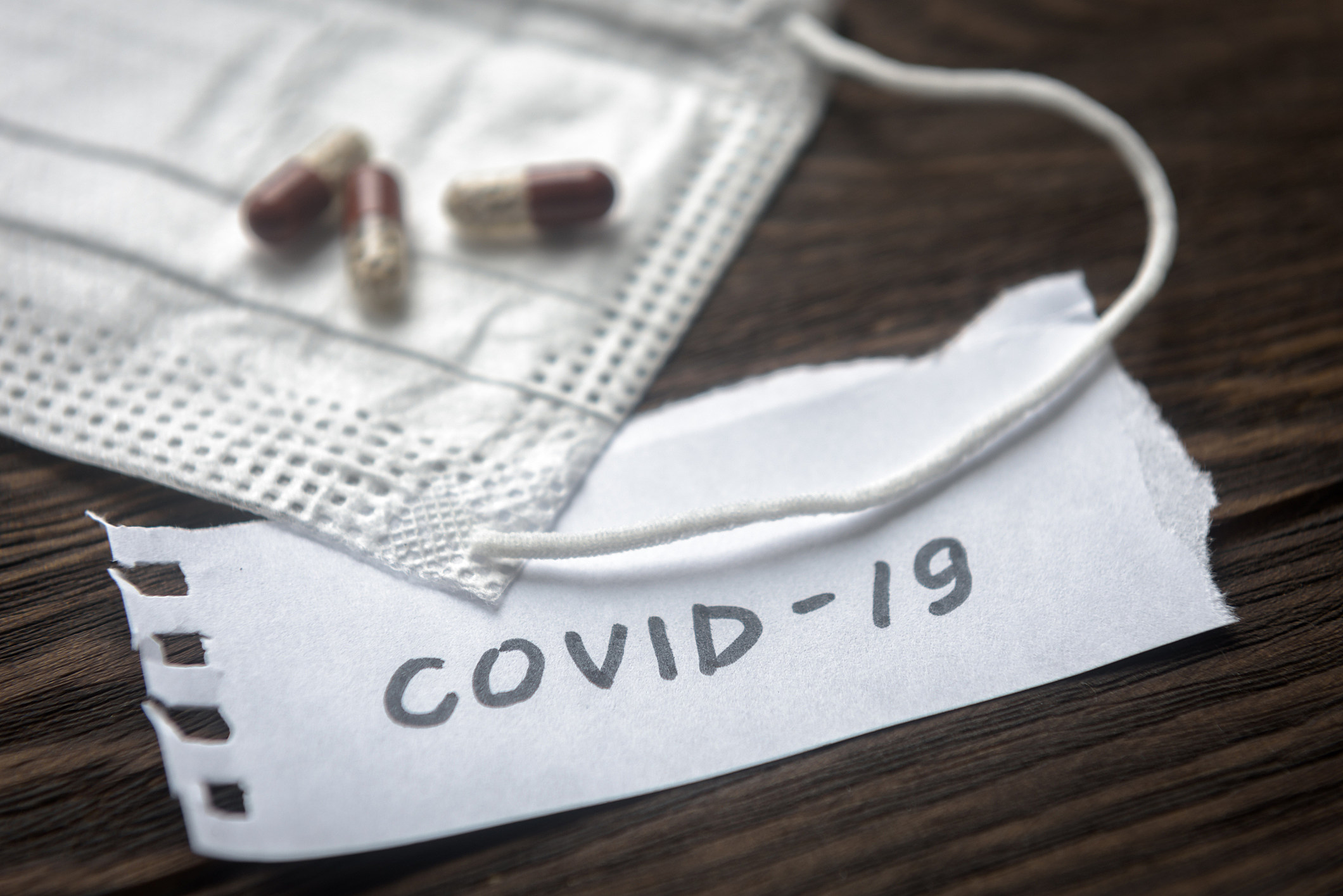 Coronavirus concept. Note COVID-19, Protective medical mask and pill capsules for treatment coronavirus. Novel corona virus outbreak.